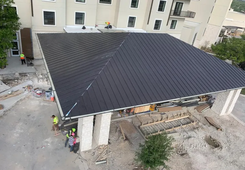 Metal roofing installation team working on a commercial building in Davison